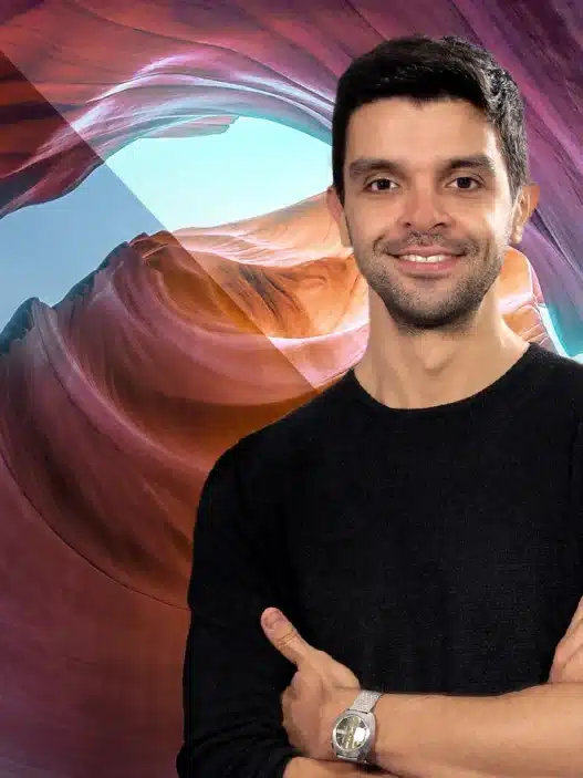 A smiling man with folded arms stands in front of a colorful canyon background, while Photoshop editing tools and the Photoshop logo appear on the left, highlighting creativity through courses online.