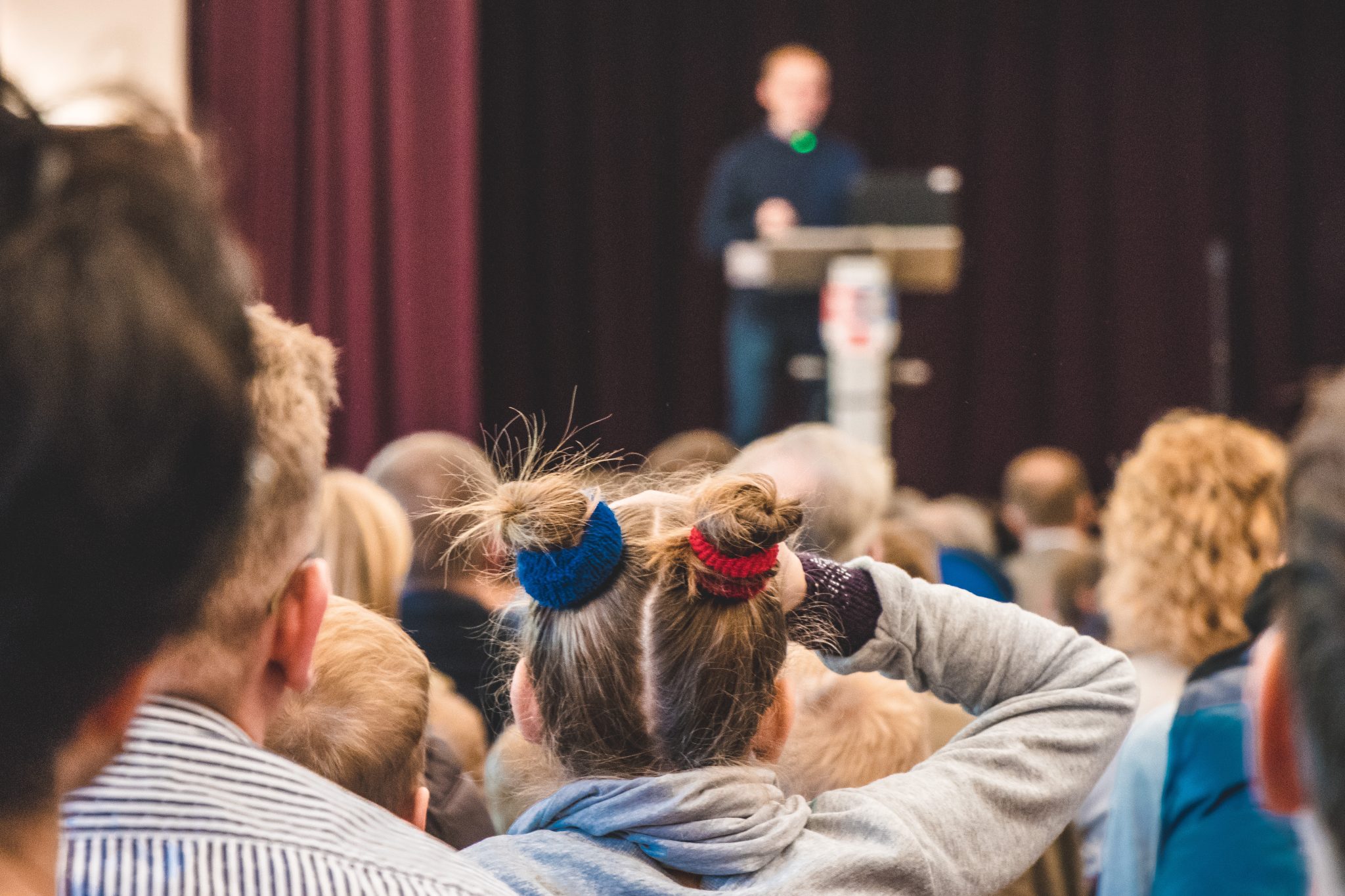 Audience listening to a speaker on stage