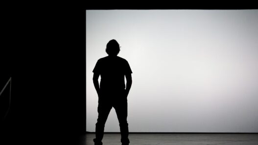 Creator presenting on a bright stage to market an online course