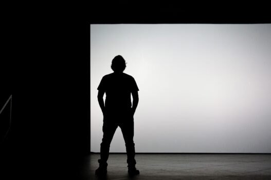 Creator presenting on a bright stage to market an online course
