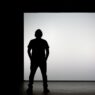 Creator presenting on a bright stage to market an online course