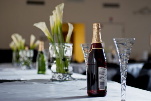 Elegantly set wedding reception table with glassware, candles, and floral details arranged by an event planner