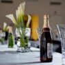 Elegantly set wedding reception table with glassware, candles, and floral details arranged by an event planner