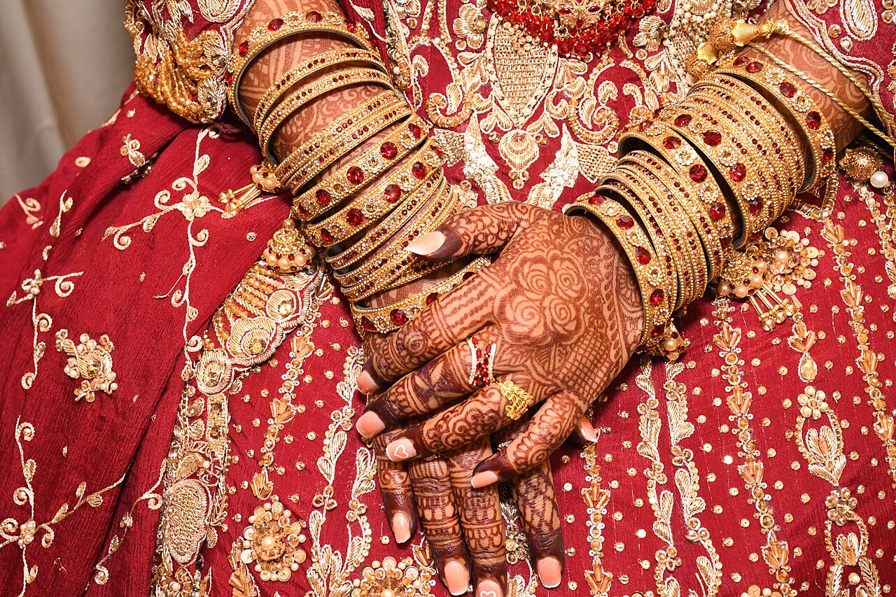Colorful wedding ceremony decoration with draped fabrics and floral arrangements