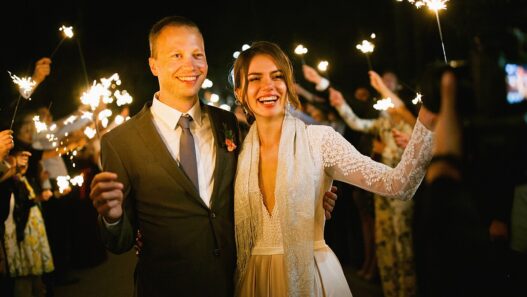 Newlywed couple embracing at their outdoor wedding ceremony