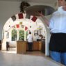 Waiter carrying a tray in a busy restaurant