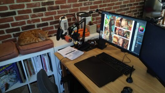 Digital artist workspace with a drawing tablet and comic artwork on screen