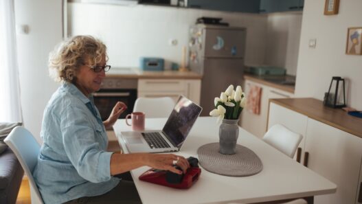 Senior woman learning on a laptop at home