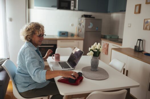 Senior woman learning on a laptop at home