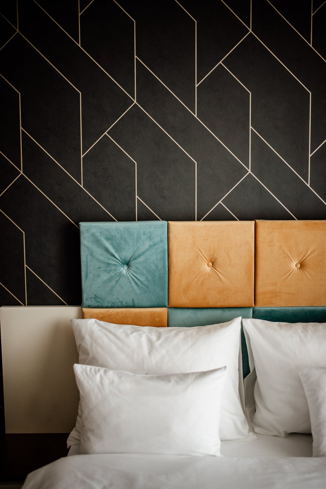 Stylish bedroom interior with unique headboard and elegant bedding