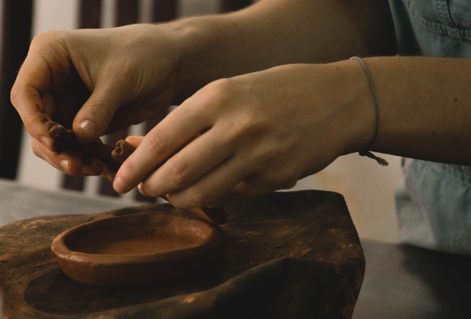 Shelves of ceramic pieces in a pottery studio