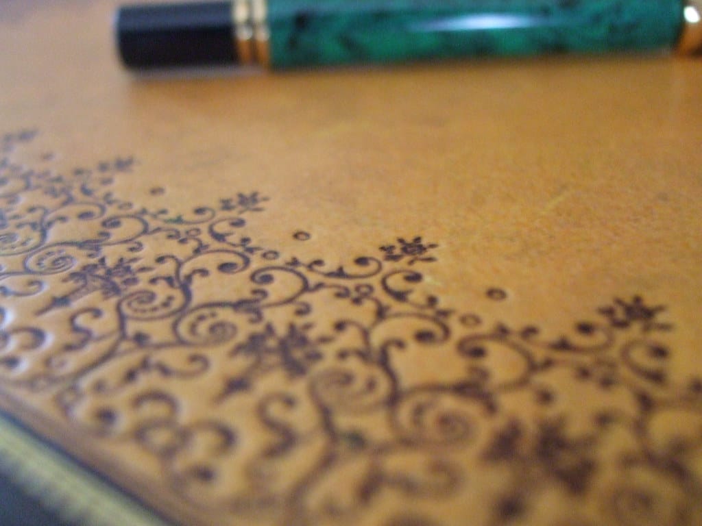Decorative notebook with a fountain pen resting on it
