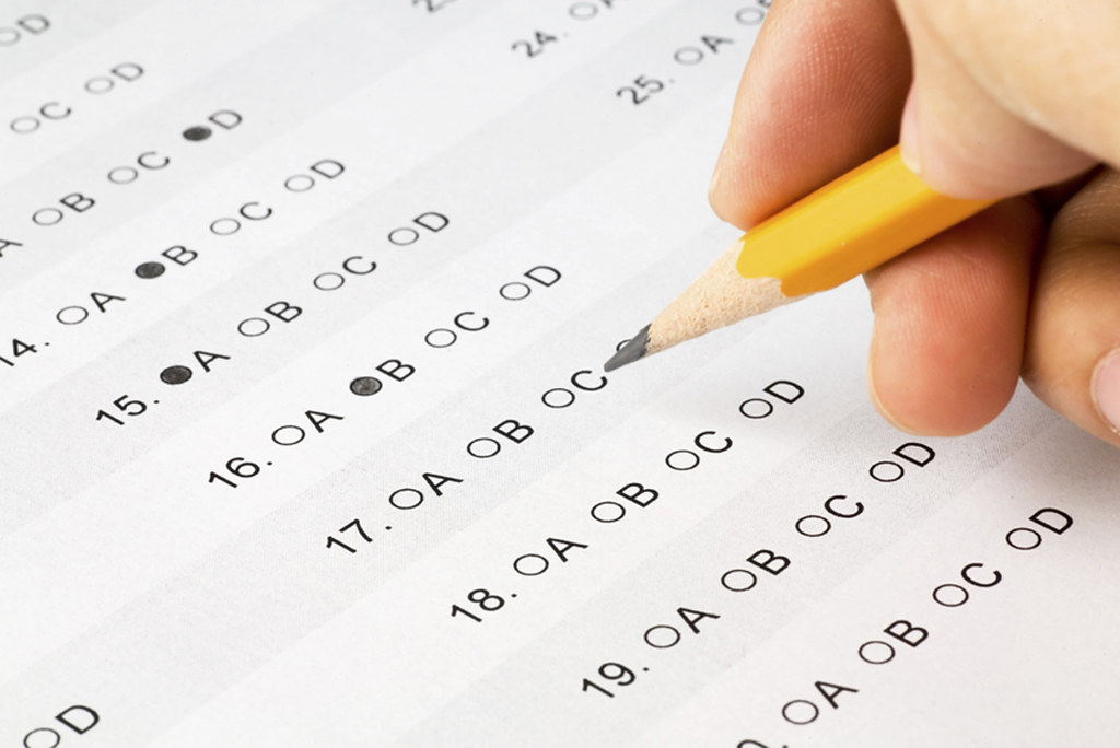 Student taking an exam with a test paper