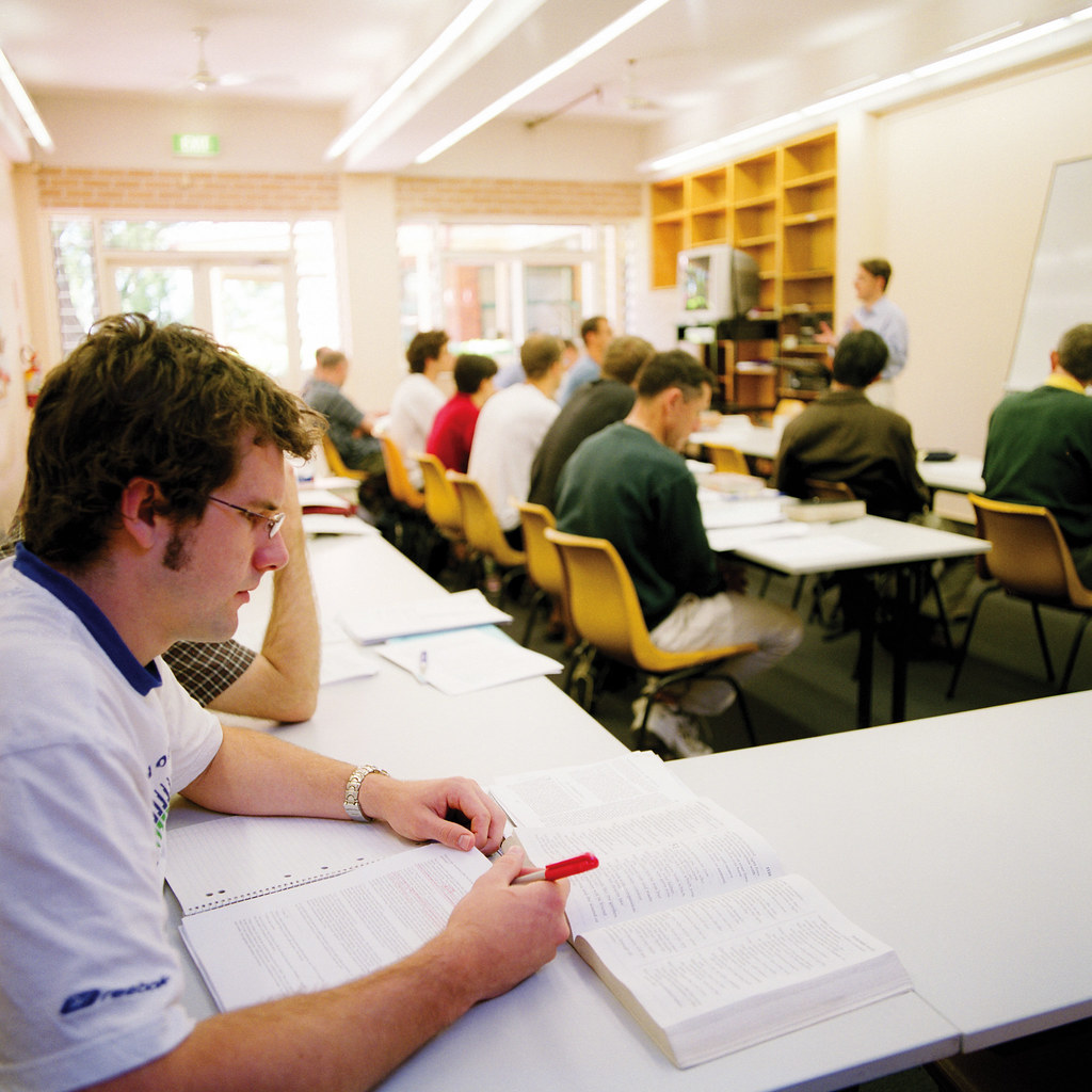 Adult students studying together in a classroom