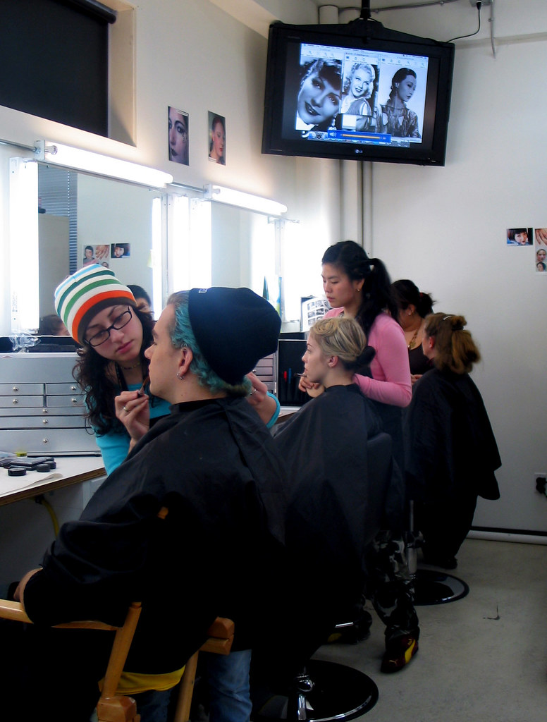 Makeup artistry students practicing makeup application in a studio class