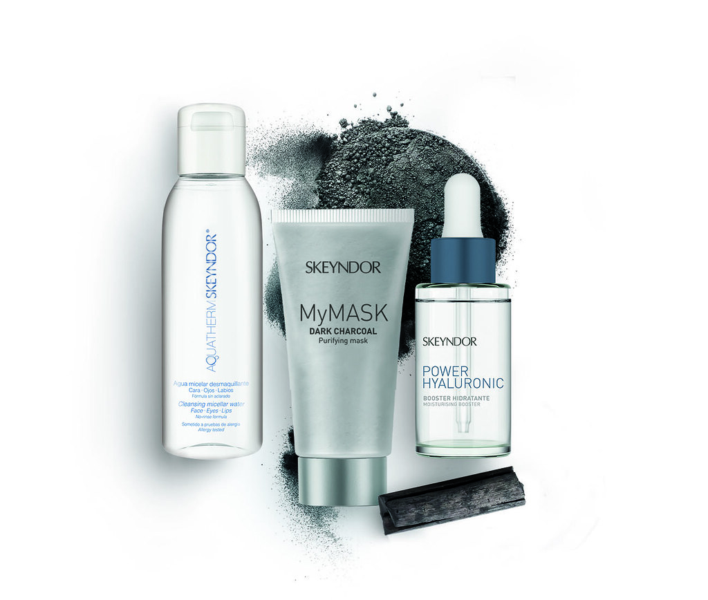 Activated charcoal powder, a popular cosmetic ingredient, on white background