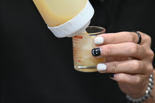Close-up of hands with black and white nail art manicure