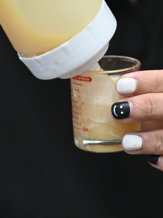 Close-up of hands with black and white nail art manicure