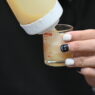 Close-up of hands with black and white nail art manicure