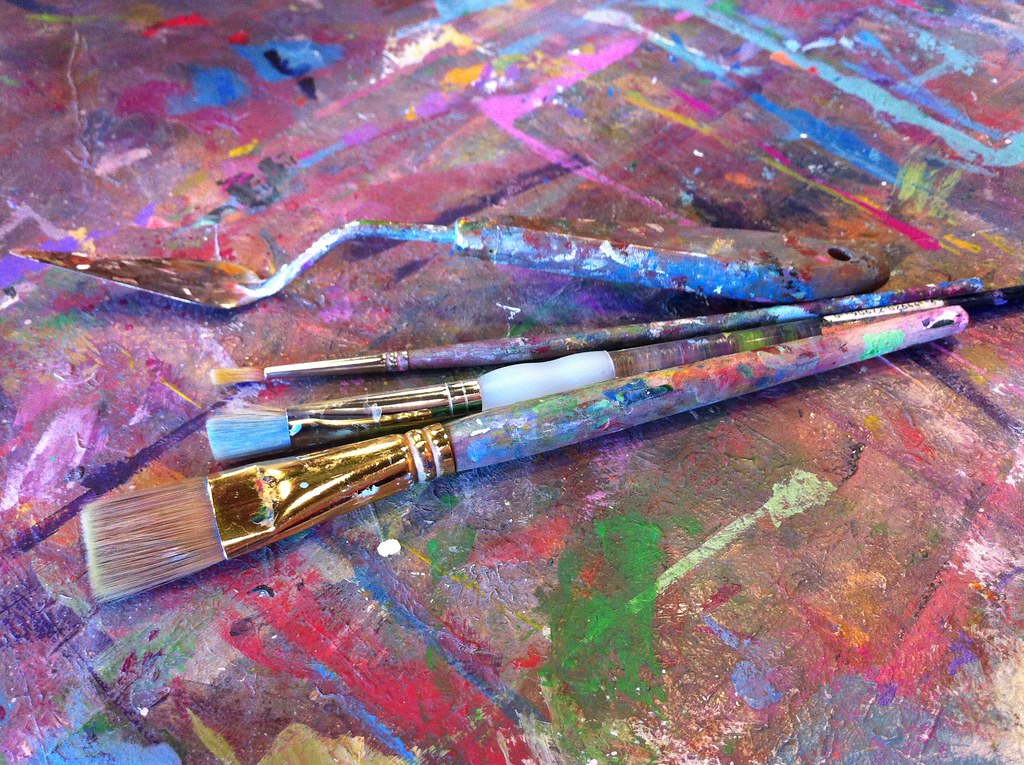 Collection of paint brushes and art supplies