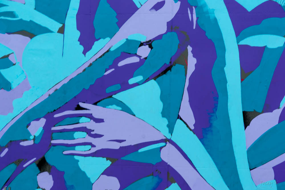 Hands painting with touches of red on canvas