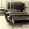 Lone student studying at a desk in a classroom