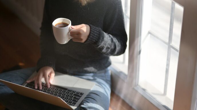 Woman freelancer working on a laptop with coffee