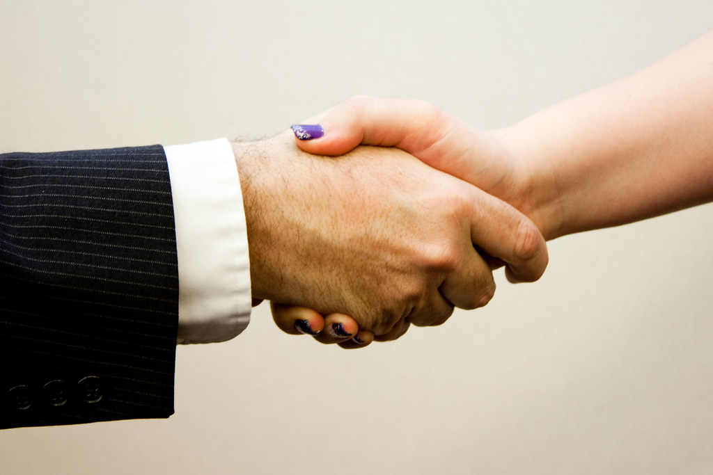 Business handshake between a man and a woman