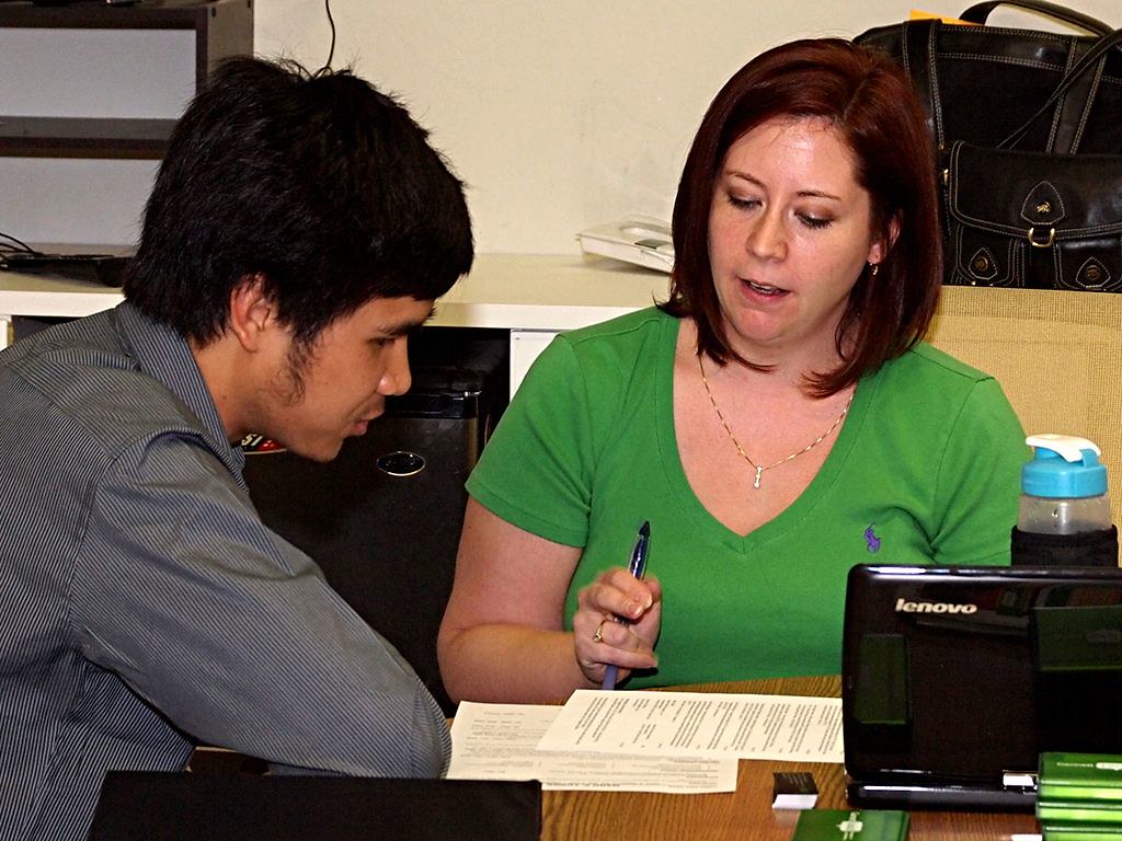 Two people reviewing a resume at a desk