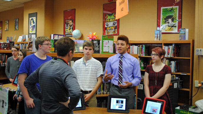 Students explaining a concept to members of the public