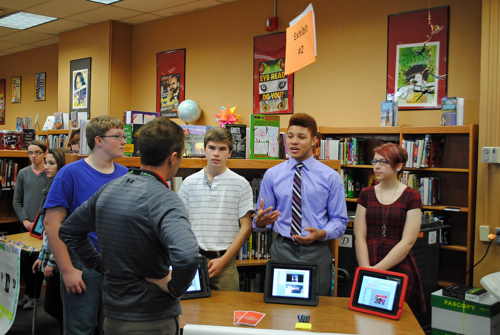 Students explaining a concept to members of the public