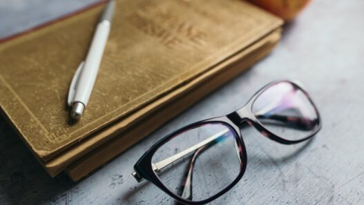 Study materials, glasses, pen and apple on a desk