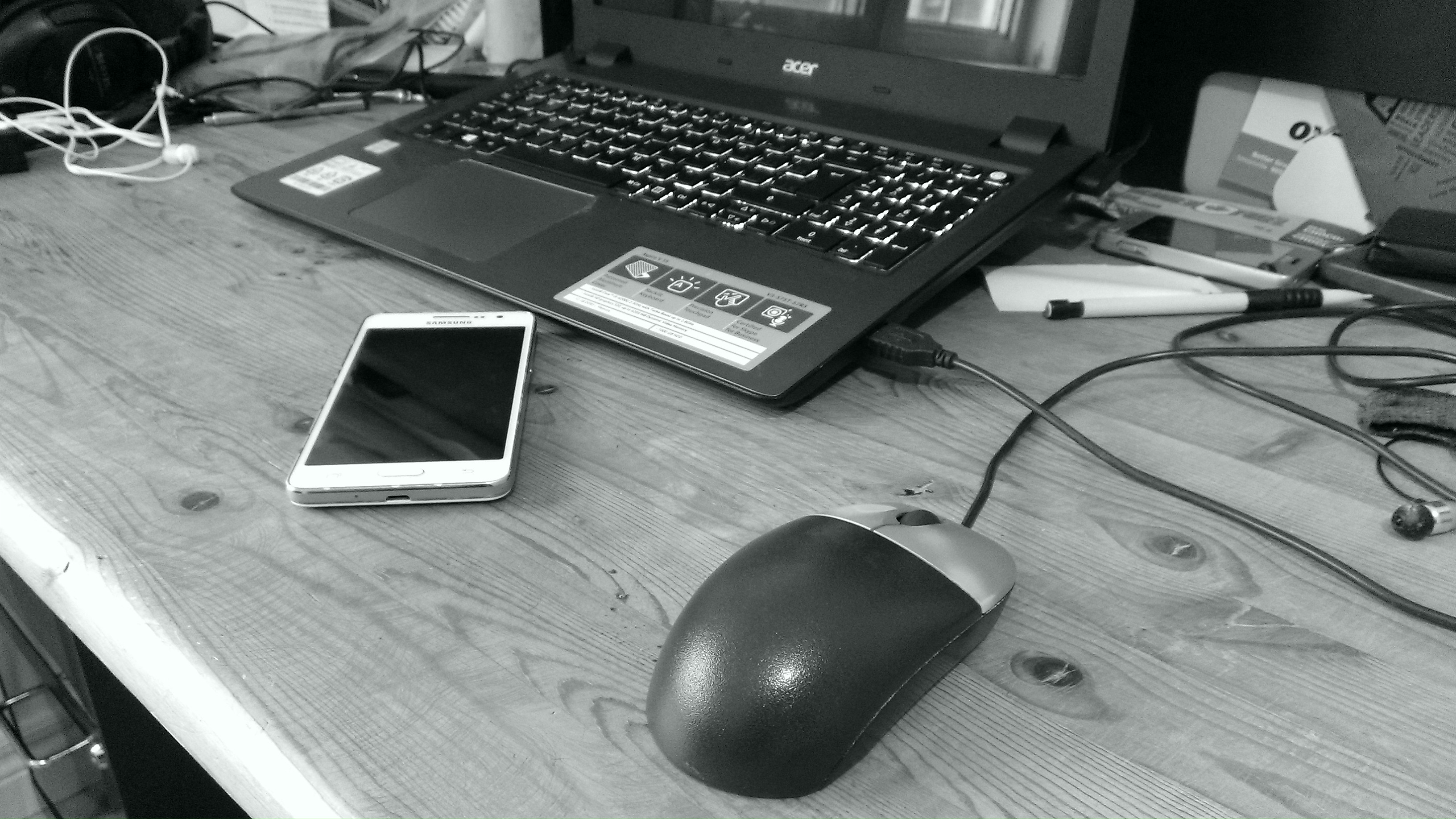 Laptop, mouse and phone on a desk