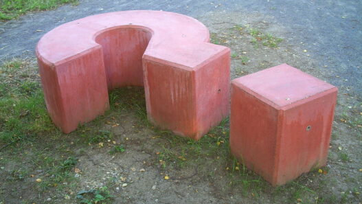 A giant concrete question mark sculpture outdoors