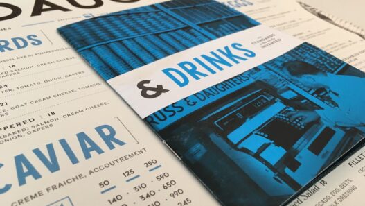 Printed restaurant menu with bold graphic design