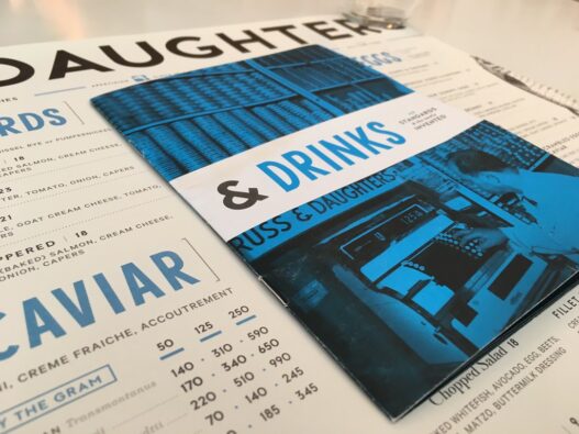 Printed restaurant menu with bold graphic design