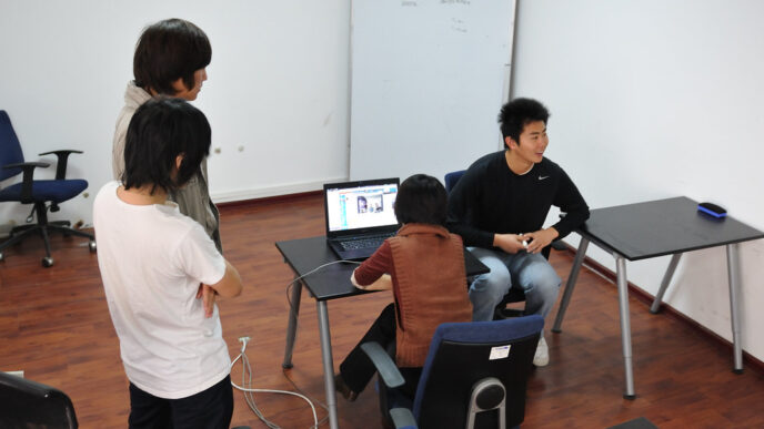 Colleagues on a video conference call, visible on a laptop screen