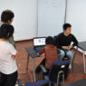 Colleagues on a video conference call, visible on a laptop screen