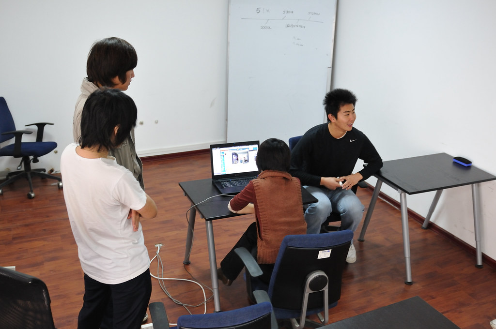 Colleagues on a video conference call, visible on a laptop screen