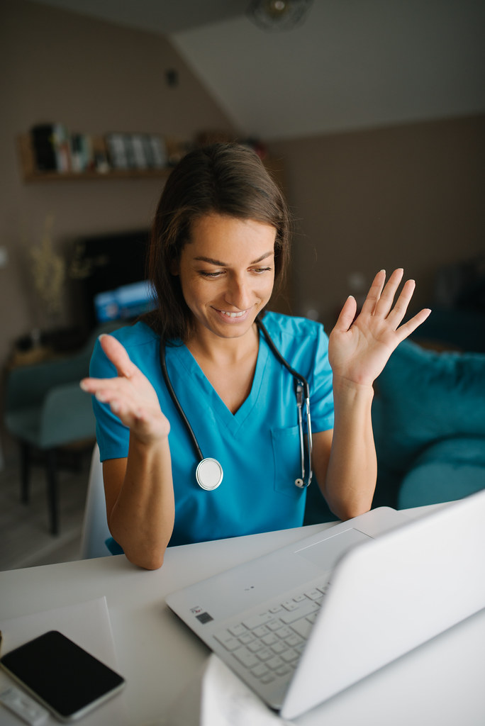 A professional on a video call, smiling at the camera