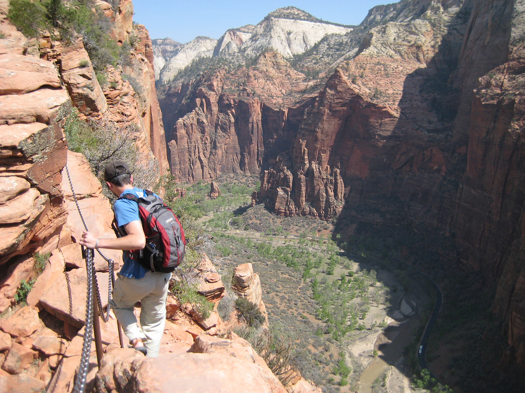 A hiker climbing a steep mountain trail