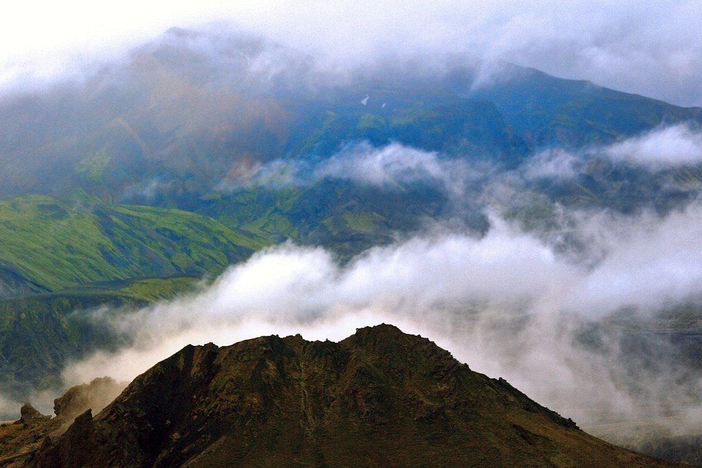 A mountain pass rising above the clouds