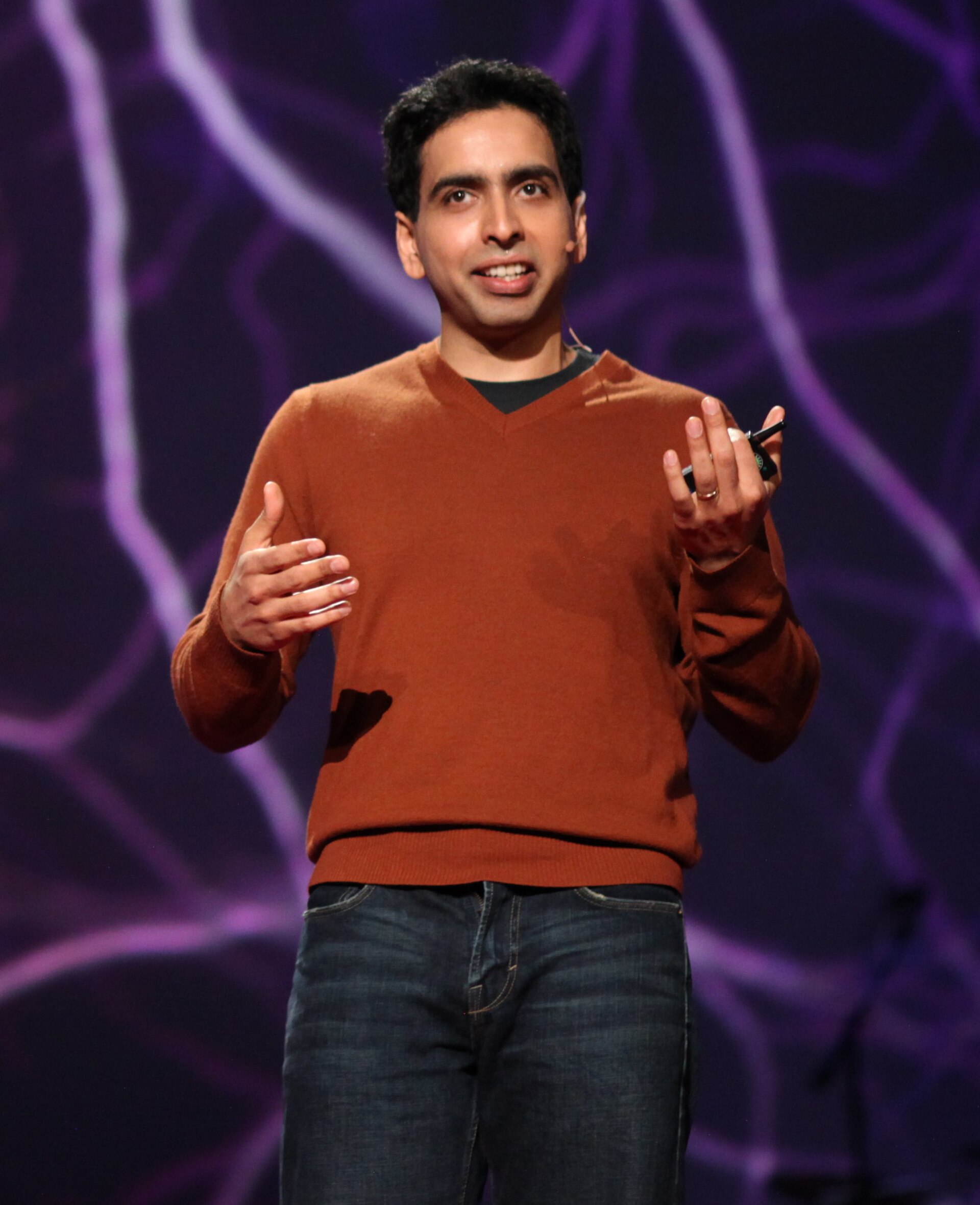 Sal Khan speaking on stage at TED 2011