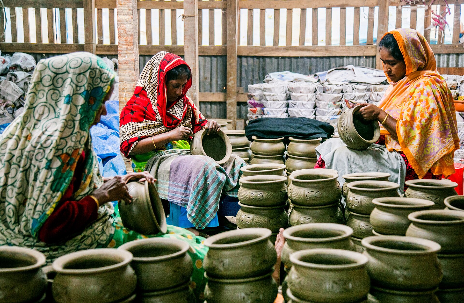 Hands shaping clay on a pottery wheel