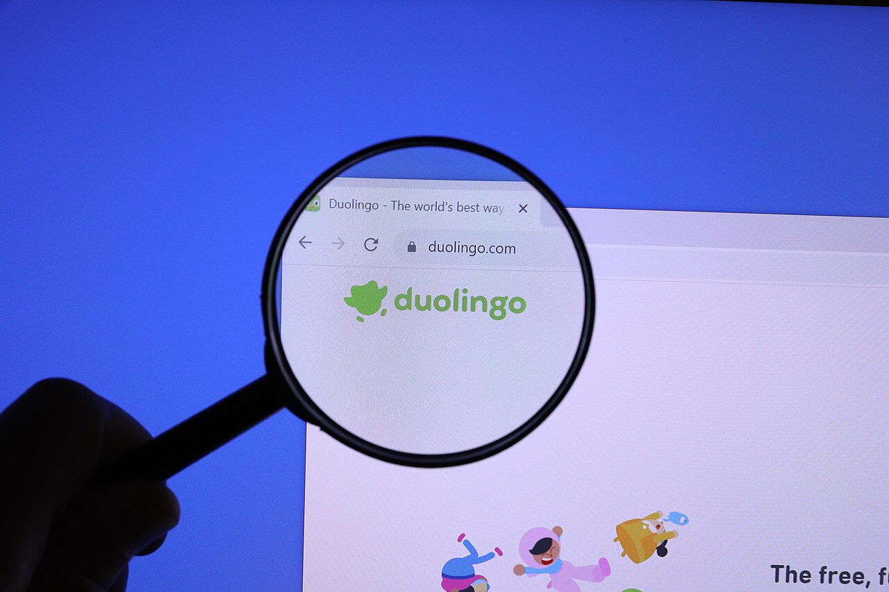 Duolingo website homepage magnified under a magnifying glass