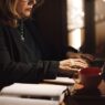 Businesswoman typing on a laptop at her home office desk