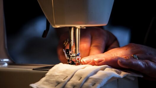 A woman sewing at a Singer sewing machine