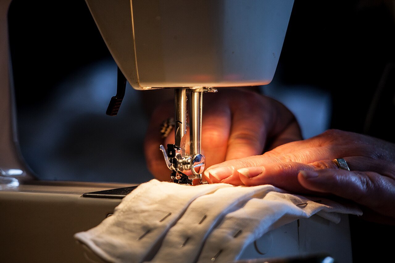 A woman sewing at a Singer sewing machine