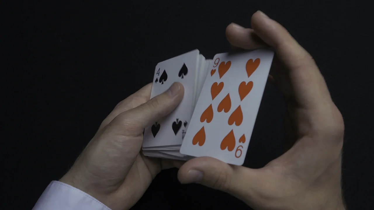 Poker game shuffling cards mans hands shuffing cards close up mans hands shuffling playing cards